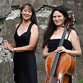 Bardin and Niskala standing outdoors with cello